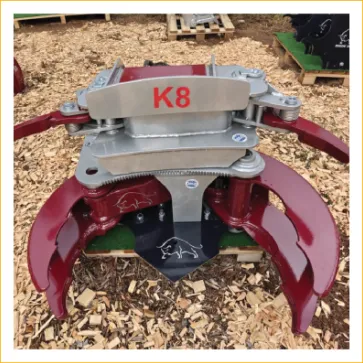K8 red single-grip industrial grapple — a feller-buncher style competitor head representative of current practice